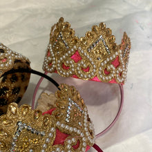 Load image into Gallery viewer, A beautiful Gold and pearl crown. In gold, flat ivory pearls. perched on top of a flexible Alice band.